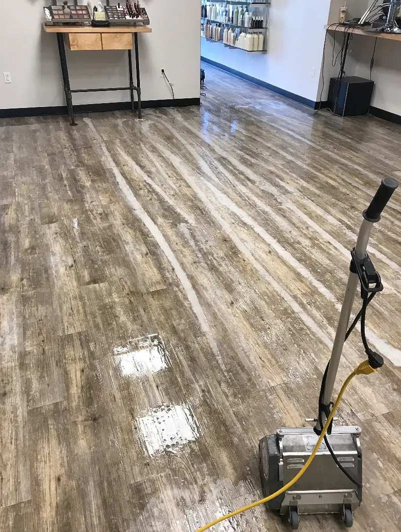 A spinner tool cleaning a luxury vinyl plank floor