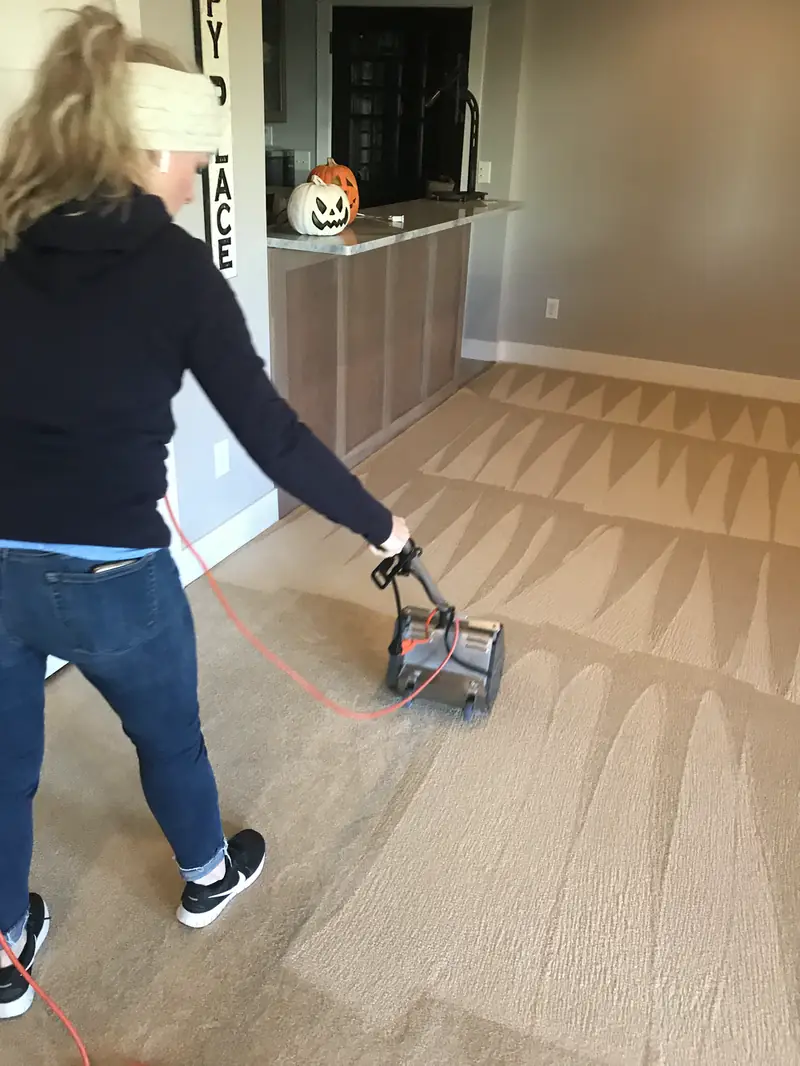 Mel running a CRB machine across a carpet