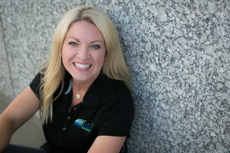 Mel Terhaar smiling in a black Clean Machine polo