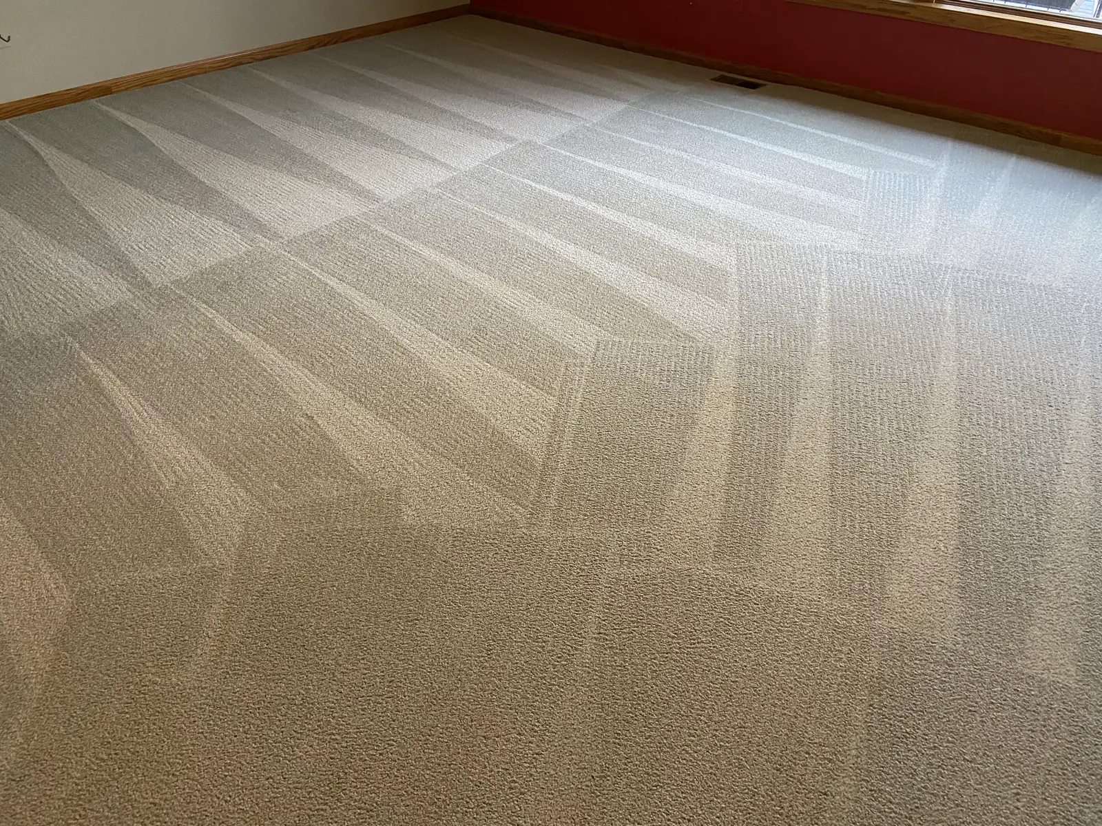 A large carpeted room with fresh wand passes across it