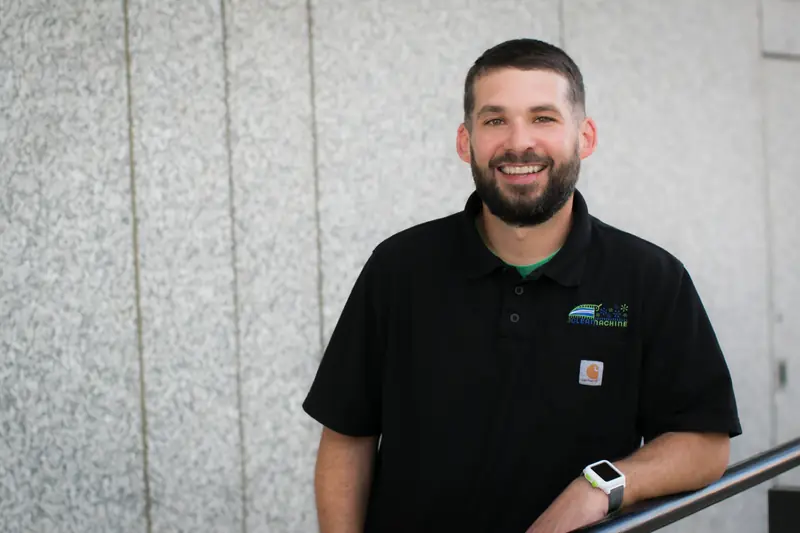 Russ Terhaar smiling in a black Clean Machine polo