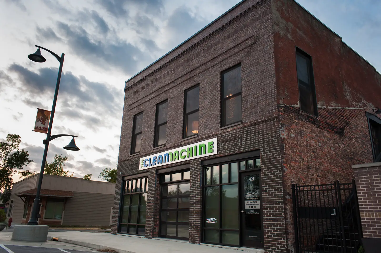 The Clean Machine storefront, a two-story brick building on Main Street in Slater