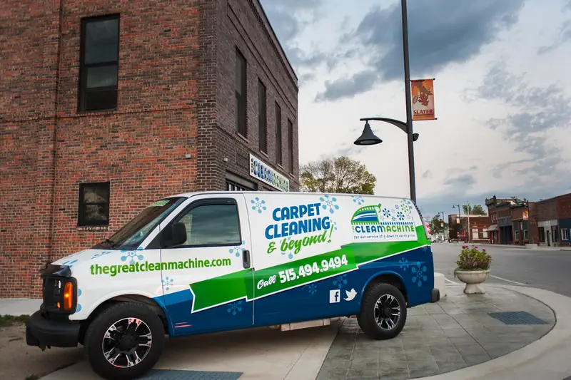 The van parked on the corner by the storefront