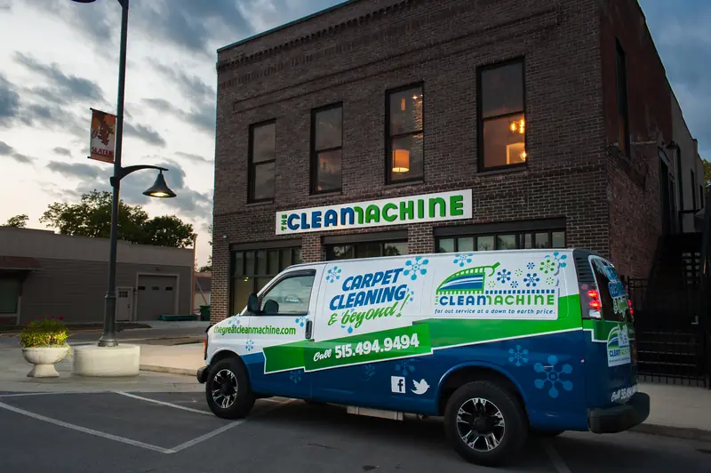 The Clean Machine van parked outside the brick storefront at dusk