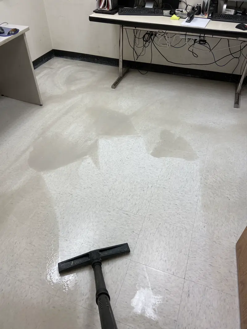 Old finish being stripped from a vinyl tile floor
